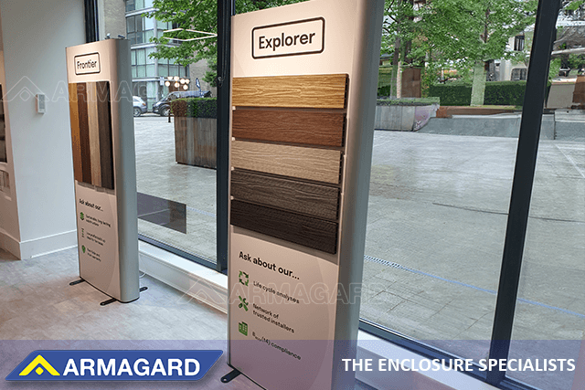 Two dual-sided digital signage advertising totems installed in a flooring company showroom