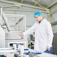 A man using a food manufacturing digital display.