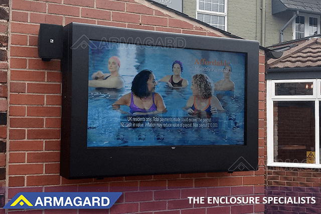 Wall-mounted landscape outdoor TV enclosure in a garden